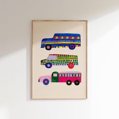 a painting on the wall depicts three buses in different colors and sizes, each painted by hand