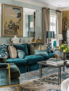 a living room filled with blue couches and pillows on top of a carpeted floor