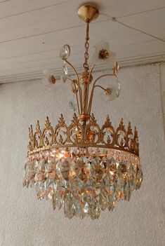 a gold chandelier hanging from the ceiling