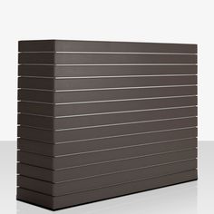 a large brown box sitting on top of a white floor next to a wall with horizontal lines