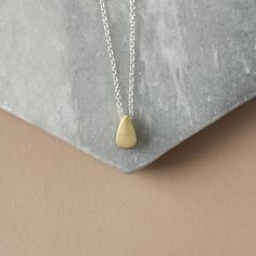 Minimal Mixed Metal Necklace - Two Tone Layering Necklace - Simple Everyday Necklace This trendy mixed metal necklace is perfect for every day and so easy to style with other jewelry. It features a raw brass teardrop paired with sterling silver cable chain for a nice contrast of tones. The teardrop is petite at 9mm tall and 5mm wide but it's also 5mm thick so the charm has some nice depth to it.  The teardrop has been given a brushed textured for some matte gold hue. The charm slides freely alon Everyday Brass Teardrop Necklace, Everyday Teardrop Brass Necklace, Gold Teardrop Pendant Necklace, Nickel Free, Gold Teardrop Charm Necklace For Everyday, Everyday Gold Teardrop Charm Necklace, Everyday Teardrop Charm Necklace With Delicate Chain, Nickel-free Teardrop Pendant Necklace For Everyday, Everyday Nickel-free Teardrop Pendant Necklace, Simple Necklace Everyday