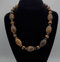 Beautiful vintage handmade carved tiger's eye bead necklace. The largest of the beads are about 3/4" wide and 1" long. 20 1/4 inches long, with a 2 1/4 inch long sterling silver extension chain. 140g Marked "925" Brown Wooden Beads Oval Jewelry, Brown Necklaces With Polished Oval Beads, Brown Jewelry With Oval Wooden Beads, Brown Wooden Oval Beads Jewelry, Unique Carved Brown Necklace, Unique Brown Carved Necklace, Antique Brown Jewelry With Large Beads, Antique Brown Necklace For Collectors, Vintage Brown Jewelry With Oval Beads