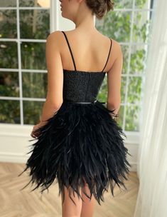 Dramatic black feathers swaddle around your body in harmony. It's intricately embellished top compliments your waist beautifully. Perfect combination of art deco and contemporary, this glamours mini dress is truly one of a kind. Glamorous Ostrich Feather Mini Dress For Cocktail, Cocktail Mini Dress With Ostrich Feathers, Elegant Ostrich Feather Mini Dress For Night Out, Evening Mini Dress With Ostrich Feathers, Chic Ostrich Feather Mini Dress For Evening, Glamorous Ostrich Feather Evening Mini Dress, Mini Gala Dresses With Feather Trim, Mini Gala Dress With Feather Trim, Glamorous Feathered Flapper Dress For Cocktails