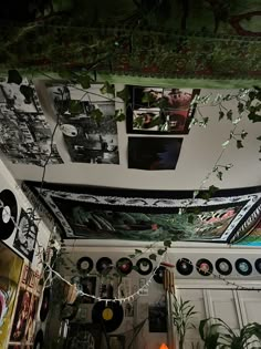 the ceiling is decorated with various records and plants hanging from it's rafters