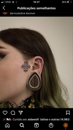 a woman with tattoos on her face and ear