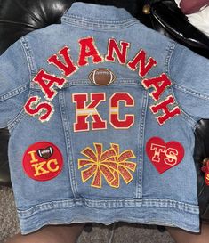 Unique Kansas City Chiefs Jean jacket.  Personalized with name. This jacket will definitely draw attention.  Your child will love this jacket!  This jacket includes the child's name , the KC patch, 5 main patches and then filler patches(stars, football, small hearts) .Any extra patches will cost $5 each.  If you would like rinestones, there will be an extra $10 charge.  Make sure you put the name in the personalization box as you want it displayed on the jacket.  Based on the length of the name, Kc Chiefs Jeans, Football Jean Jacket, Painted Jean Jacket School Spirit, Patch Denim Jacket, Letterman Jacket Ideas, Football Mom Outfit, Jean Jacket Diy, Jean Jacket Patches, Custom Jean Jacket