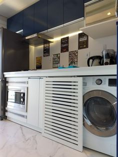 a washer and dryer in a kitchen with marble counter tops on the floor