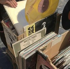 several records are stacked on top of each other in an old record player's box