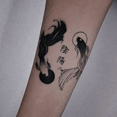 a woman's arm with a tattoo on it that has an image of two fish