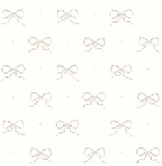 a white wallpaper with bows and dots in the middle, all on one side