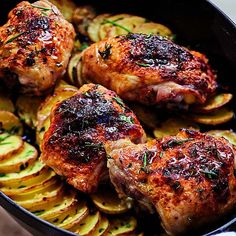 chicken and potatoes in a pan with herbs