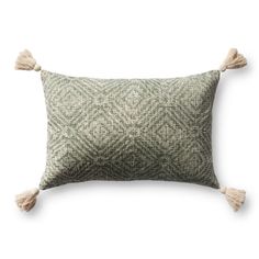 a green and white pillow with two tassels on the front, one in grey and