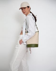 An iconic, leather-trimmed, cotton linen canvas bucket bag • Shoulder Strap Drop: 26- 29"• Crossbody Strap Drop: 40"-47"• Height: 11"• Width: 8"• Depth: 8" • 60% cotton/ 40% linen with 100% genuine leather trim• fully lined• magnetic snap closure• interior zip pocket• adjustable, removable shoulder strap• extra crossbody strap• spot clean Canvas Bucket Bag For Errands, Canvas Crossbody Bucket Bag For Travel, Canvas Crossbody Bucket Bag For Errands, Bucket Canvas Bag With Leather Trim, Designer Canvas Bucket Bag For Travel, Summer Shoulder Bag With Leather Trim For Errands, Luxury Canvas Bucket Bag, Canvas Bucket Bag With Leather Trim For Shopping, Canvas Bucket Shoulder Bag With Leather Trim