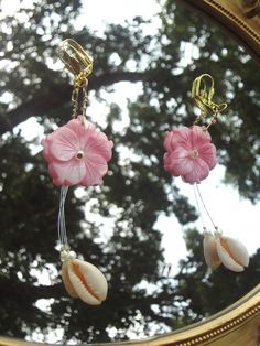 ✧ ೃ༄ Length: ~4.6 in ✧ ೃ༄ Carefully put together with super cute shell carved pink flowers, cowrie shells, tiny pearls, and illusion cord to give the effect of the dangling cowrie shells. ✧ ೃ༄The earring hooks and wire are gold in color. Summer Dangle Jewelry With Flower Decoration, Bohemian Flower Charm Jewelry For Beach, Summer Vacation Jewelry With Flower Shape, Summer Flower Jewelry For Vacation, Flower-shaped Summer Vacation Jewelry, Summer Vacation Flower-shaped Jewelry, Bohemian Flower Earrings For Vacation, Pink Dangle Jewelry For Vacation, Bohemian Flower Earrings For Summer Beach