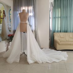 a mannequin with a wedding dress on display