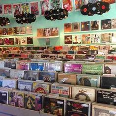 there are many records on the shelves in this music store that is filled with cds