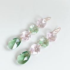 These ultra fancy shimmering chandelier drop earrings will add a touch of elegance to any personal style. The fancy earrings feature style options pink with green or purple with pink crystals. The crystals have an increased number of facets, creating alternations from small to large facets, making them simply beautiful. The 14k rose gold filled delicate design is hand sculpted, hammered, sanded and polished by artisan, Lisa Ramos in the San Francisco Bay Area. It comes wrapped in a velvet bag fe Elegant Pink Crystal Drop Earrings, Pink Dangle Crystal Earrings, Affordable Pink Crystal Metal Earrings, Pink Hypoallergenic Dangle Crystal Earrings, Pink Metal Dangle Crystal Earrings, Rose Gold Chandelier, Pink Crystal Chandelier, Fancy Earrings, Pink Swarovski