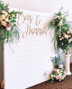 two white vases filled with flowers next to a sign that says easy and elegant