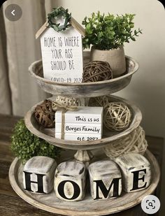 three tiered trays holding plants and signs that read home is where your fab should be