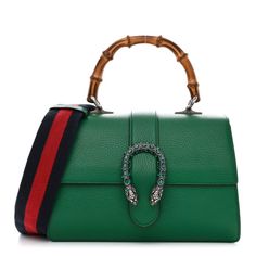 This is an authentic GUCCI Dollar Calfskin Crystal Web Medium Dionysus Bamboo Top Handle Bag in Emerald. This exquisite bag is crafted of textured calfskin leather. The bag has a sturdy bamboo top handle, an optional webbed nylon shoulder strap and a prominent crystal-embellished tiger head horseshoe closure. The flap opens to reveal a natural fabric partitioned interior with patch pockets and a central dividing zipper compartment. Gucci Calf Leather Satchel Shoulder Bag, Gucci Calf Leather Shoulder Bag, Gucci Calf Leather Shopping Bag, Gucci Calf Leather Bags With Gold-tone Hardware, Gucci Evening Bag In Calf Leather, Gucci Calf Leather Evening Bag, Gucci Evening Calf Leather Bag, Gucci Leather Top Handle Shoulder Bag, Green Gucci Bag With Detachable Handle