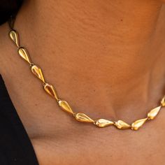 The Story This chic gold chain necklace is the ultimate jewelry staple. Made from rich 18 karat yellow gold, the necklace measures 15.5 inches and sits at the collar bone. Comprised of 25 tear-dropped shaped links, the length is perfect for a shorter, choker look. Made by Birks, an heirloom Canadian brand founded in 1879, the construction is lovely. Each of the links is semi-hollow, so while the necklace has a lovely presence, it's not too heavy. It looks great on its own or worn layered with ot Formal Teardrop Chain Necklace With Adjustable Chain, Formal Gold Drop Necklace With Chain, Timeless Gold Pear-shaped Necklace, Formal Gold Plated Teardrop Necklaces, Yellow Gold Teardrop Necklace With Chain, Formal Teardrop Chain Necklace, Classic Gold Pear-shaped Drop Necklace, Formal Gold Drop Necklace, Formal Drop Chain Necklace