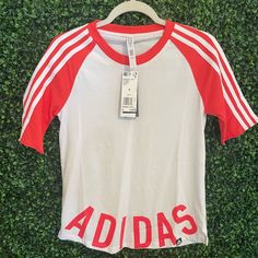 Jersey Style Shirtlogo At The Bottom. Cotton Moisture Whisking Material. White And Coral Color. Never Worn. Nwt Adidas Logo Tops For Spring, Summer Adidas Logo Top, Adidas Logo Summer Top, White Adidas Tops For Spring, Spring Cotton Top With Adidas Logo, Summer Adidas Crew Neck Top With Logo, Adidas Logo Short Sleeve Tops For Summer, Adidas Summer Tops With Three Stripes, Adidas Three Stripes Summer Tops