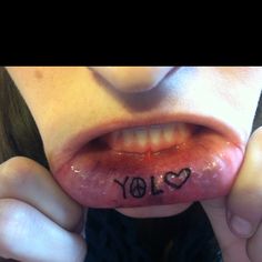 a woman holding up her tongue with the word joy written on it's lip