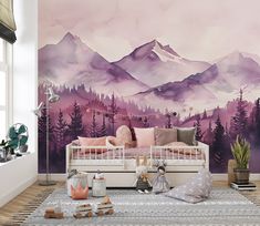 a living room with mountains painted on the wall and furniture in front of it,