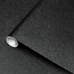 a close up view of a black leather textured surface with a round hole in the middle