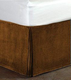 a bed with a brown skirt on top of it