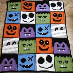 a crocheted blanket with many faces on it