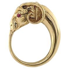 This striking figural ring is sort of a modified ouroboros -- the ancient round symbol of a snake eating its own tail -- only here the snake has the head of a ram. This whimsical mash-up of motifs puts it squarely in the mini-Etruscan revival of the 1940s and 1950s, when designs were informed by ancient artifacts, but didn't really have the imitative rigor of the first Etruscan Revival in the mid-19th Century. Substantial and gracefully proportioned, with outstanding detail at the head, this ram 1980s Retro Fashion, Snake Eating, Tiger Ring, Head Ring, Ring Mountings, Bow Ring, Oval Rings, Ancient Artifacts, A Snake