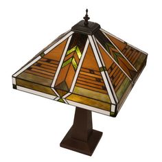 a stained glass table lamp on a wooden base with a brown base and green accents