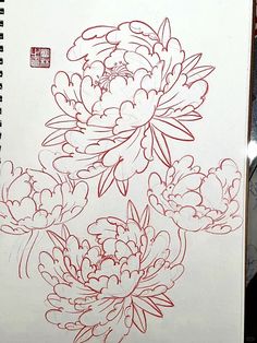 a drawing of flowers is shown in red ink on a white paper with chinese writing