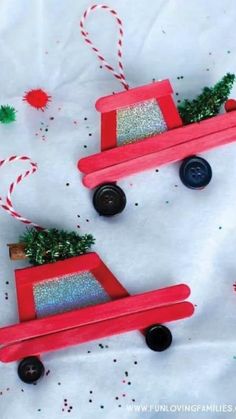 two wooden toy cars with christmas decorations on them