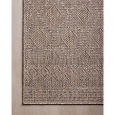 a beige rug with an abstract design on it