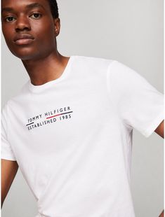 Tommy Hilfiger men's T-shirt. Made from lightweight cotton jersey, known for its breathability and stretch, our comfortable crewneck tee is cut in an easy fit and finished with our embroidered logo.  Material: 100% Cotton. Tommy Hilfiger Graphic Print Crew Neck T-shirt, Tommy Hilfiger Cotton Logo T-shirt, Tommy Hilfiger Logo Print Crew Neck T-shirt, Tommy Hilfiger Crew Neck T-shirt With Logo, White Cotton Tommy Hilfiger T-shirt, Tommy Hilfiger Relaxed Fit Tops With Logo Print, Tommy Hilfiger Relaxed Fit Logo Print Tops, Tommy Hilfiger Cotton T-shirt With Text Print, Tommy Hilfiger Logo Print Cotton T-shirt