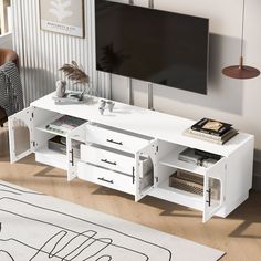 a living room with a white entertainment center