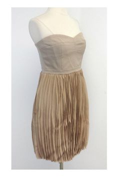 Size 10 Angel strapless pleated skirt dress in pumice Retails for $388.00 Body 70% Polyester 28% Rayon 2% Spandex Contrast 100% Polyester Lining 100% Polyester Concealed back zip and clasp Bone in bodice Silicone strip inside bust Has original tag Across top of bust 17" Under bust 15.25" Waist 29" Hips 41" Total length 28.5" Spring Strapless Mini Dress With Pleated Bodice, Fitted Knee-length Pleated Dress For Night Out, Fitted Pleated Mini Dress With Sweetheart Neckline, Strapless Pleated Skirt Dress, Strapless Mini Dress With Pleated Bodice For Spring, Strapless Pleated Party Dress, Formal Strapless Dress With Pleated Waist, Chic Strapless Pleated Mini Dress, Chic Strapless Dress With Pleated Bodice For Date Night