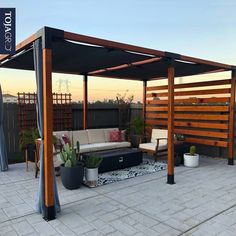 an outdoor living area with couches, chairs and a wooden pergoline structure