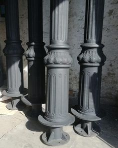 three black and white pillars sitting next to each other