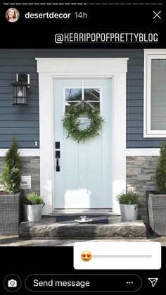 the front door is decorated with wreaths and potted plants