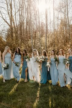 a group of women standing next to each other on top of a lush green field