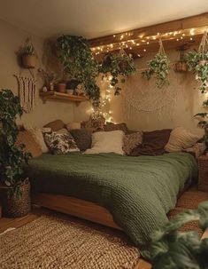 a bedroom with plants hanging from the ceiling and lights on the wall above the bed