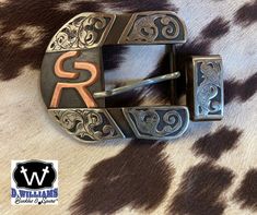 Handcrafted custom belt buckle. Each piece is carefully crafted by Duayne in the great state of Texas.  Overlays are available in Silver, Copper, or a combination. "Each piece tells a story and takes on a life of its own. It starts with the raw material and then turns into a handcrafted work of art special to each customer." Duayne Williams There are several styles to choose from. Please see the photo of the styles available and indicate which letter style you would like.  Most buckles are 1 1/2 Custom Engraved Belt Buckles For Formal Occasions, Custom Belt Buckles, Cowboy Belt Buckles, Cattle Brands, Western Belt Buckles, Custom Belt, Rodeo Cowboy, Western Belt, State Of Texas