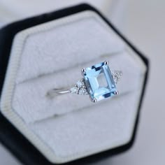 The default design option features 9x7mm Emerald Cut Aquamarine Blue, VVS1-Clarity, VG-Cut, Ex-Polish, VG-Symmetry set With D-Colorless Moissanite in 14K White Gold Engagement Ring. Model 709-9x7mm Also you can fully customize and engrave this ring by clicking the button "Personalize in 3D". As well please remember it takes up to 19-21 days to make and ship this item. Emerald Cut Aquamarine Engagement Ring, Aquamarine Engagement Ring White Gold, Emerald Cut Aquamarine Ring, Aquamarine Solitaire Ring, Wedding Rings Emerald Cut, Wedding Studs, Blue Topaz Engagement Ring, Blue Engagement Ring, Ring Model