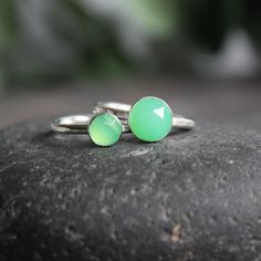 This stone is such a pretty shade of green! Chrysoprase is the gemstone for the broken hearted...who knew? This ring has a sturdy ring band with a 6mm or 8mm rose cut chrysoprase cabochon set in a sterling silver bezel. It can be worn with other stackable rings, or by itself. Handmade by Barb Macy in Corvallis, OR. Green Sterling Silver Stackable Rings For May Birthstone, Adjustable Green Opal Ring, Green Chalcedony Gemstone Rings, Handmade Green Chalcedony Rings, Green Gemstone Stackable Rings For May Birthstone, Green Stackable Rings For May Birthstone, Green Opal Ring In Sterling Silver For Gift, Green Opal Ring In Sterling Silver As Gift, Adjustable Green Opal Ring Gift