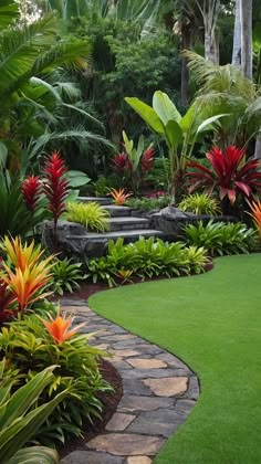 a lush green garden with red and yellow flowers in the foreground, surrounded by palm trees