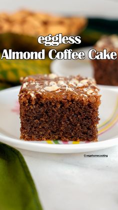 a close up of a piece of cake on a plate with the words eggless almond coffee cake