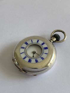 ANTIQUE Ladies Solid Silver Half Hunter Victorian Fob Pocket Watch. Hallmarked 900 Continental Silver. Ref no. 370 Beautiful half hunter case with white enamel chapter ring to outer case with blue roman numerals. Inner white enamel dial having black roman numerals & blue steel hands. Mechanical Swiss movement. Bow wound. Watch dimensions - 24mm diameter. Height inc. bow 37mm. This watch is sold with a 12 month guarantee from MBHI certificated watchmakers, established 1947. All watches will be serviced before shipping hence the 2-3 week dispatch. Please note - Watches are not waterproof unless otherwise stated and it is recommended not to wear them near water (i.e. washing hands, washing up, shower, swimming etc). Antique Chronometer Watch Accessories, Vintage Silver Pocket Watch With Round Dial, Vintage Silver Watch Accessories With Polished Finish, Antique Silver Watch With Round Dial, Antique Silver Collectible Watches, Vintage Silver Watch With Subdials, Vintage Silver Watch With Metal Dial, Vintage Engraved Watch Accessories With Round Dial, Vintage Collectible Pocket Watch With Subdials